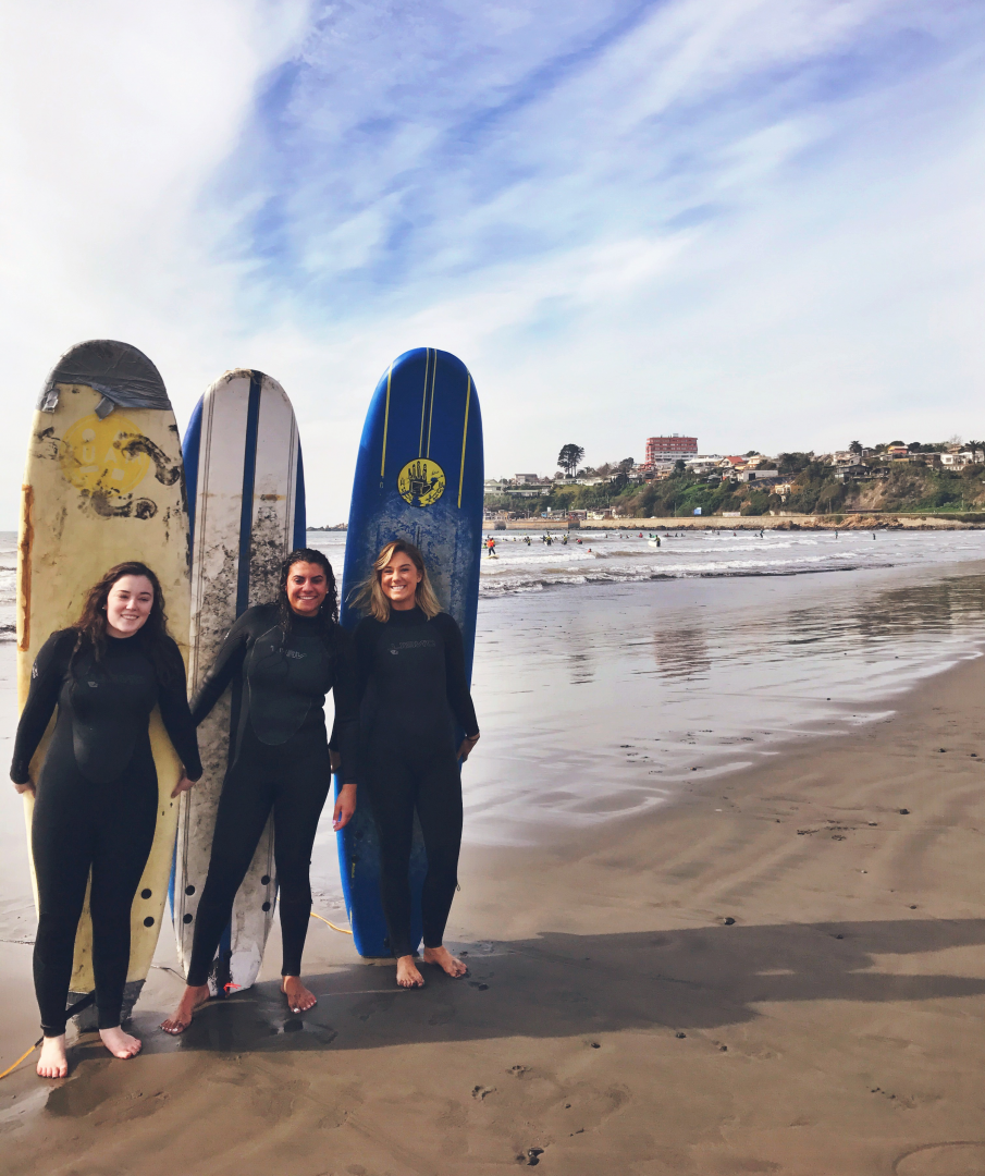 Caption: Left to right: Cailey Cotter, Brianna Camara and Kathryn Limerick surfed off the coast of Chile.