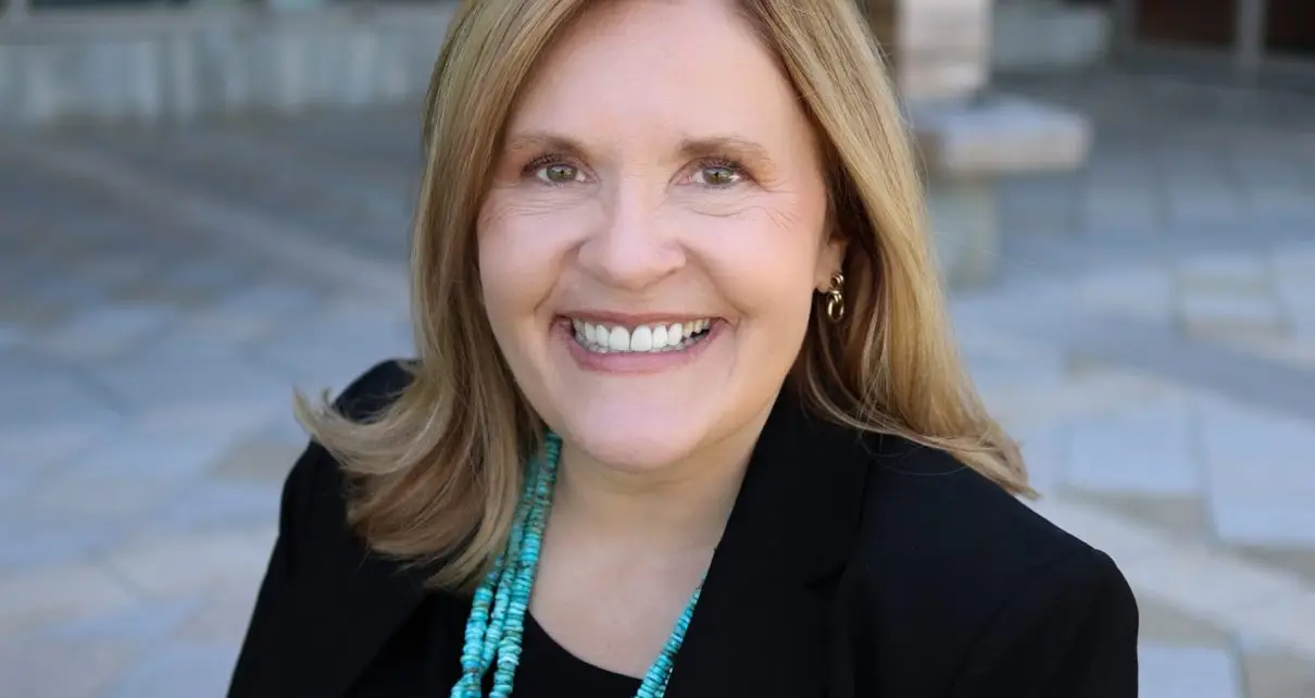 A portrait of SNHU President Lisa Marsh Ryerson sitting in front of the Wolak Library Learning Commons.